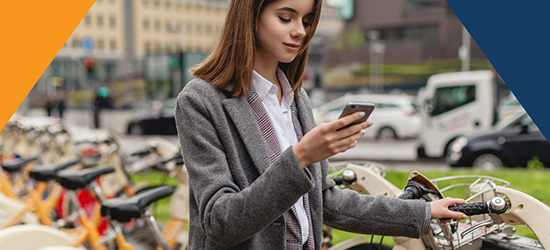Woman looking at phone, choosing a bike image