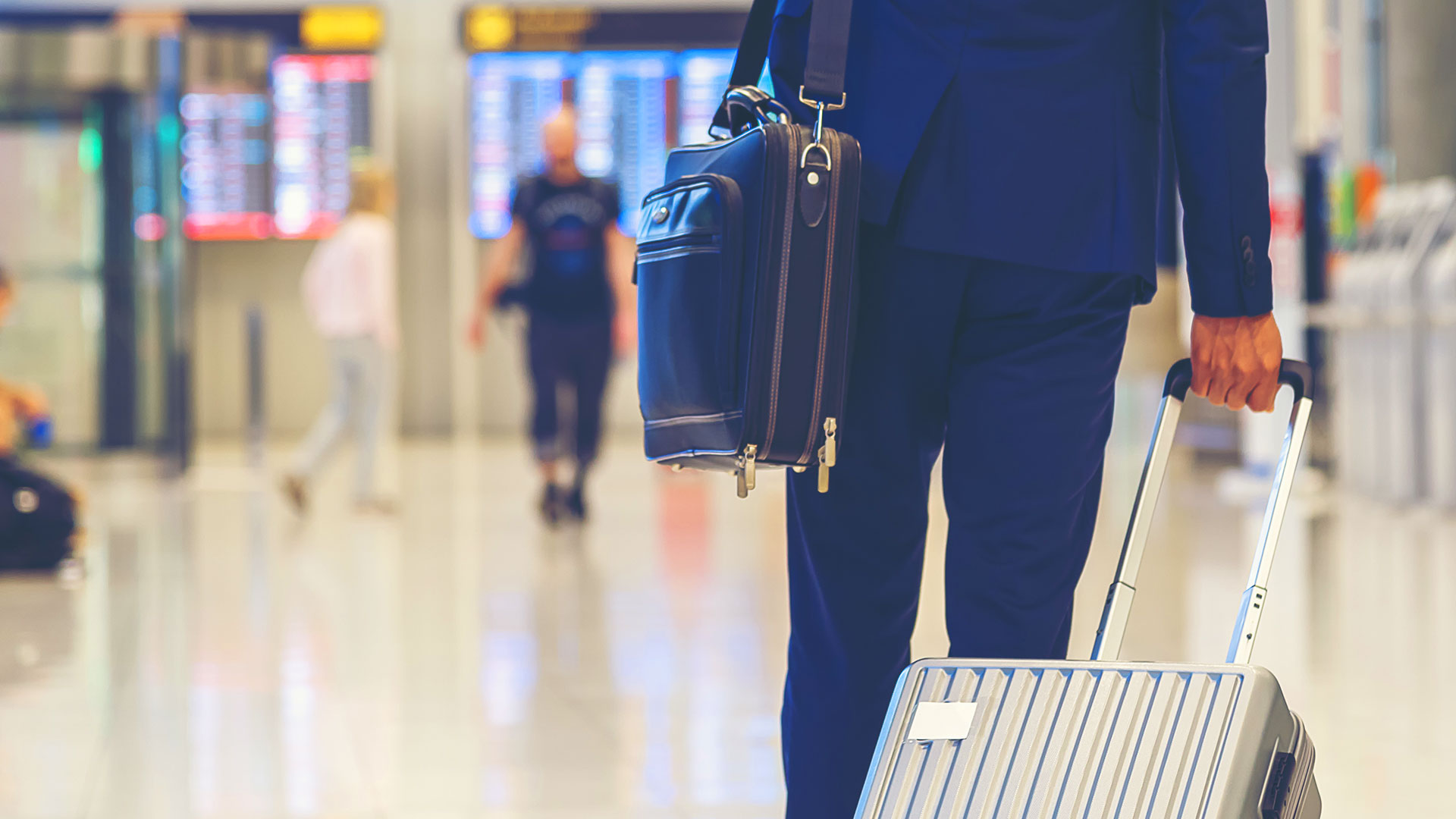 Man walking through terminal with luggage