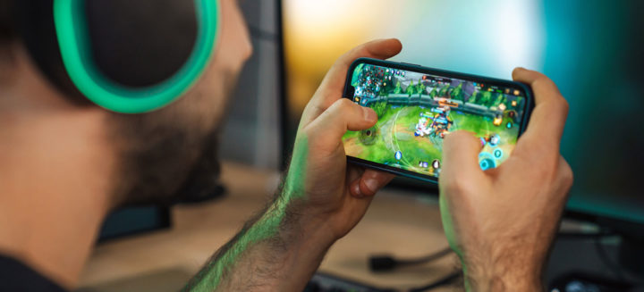 Gamer playing video games on smartphone