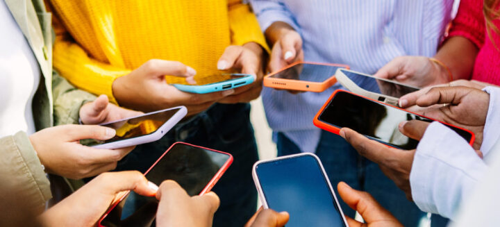 Young group of people using mobile phones together